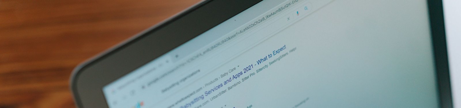 A close-up view of a laptop displaying a search engine page.